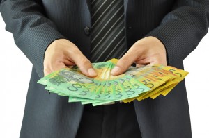 Businessman hands holding money - Australian dollar bills